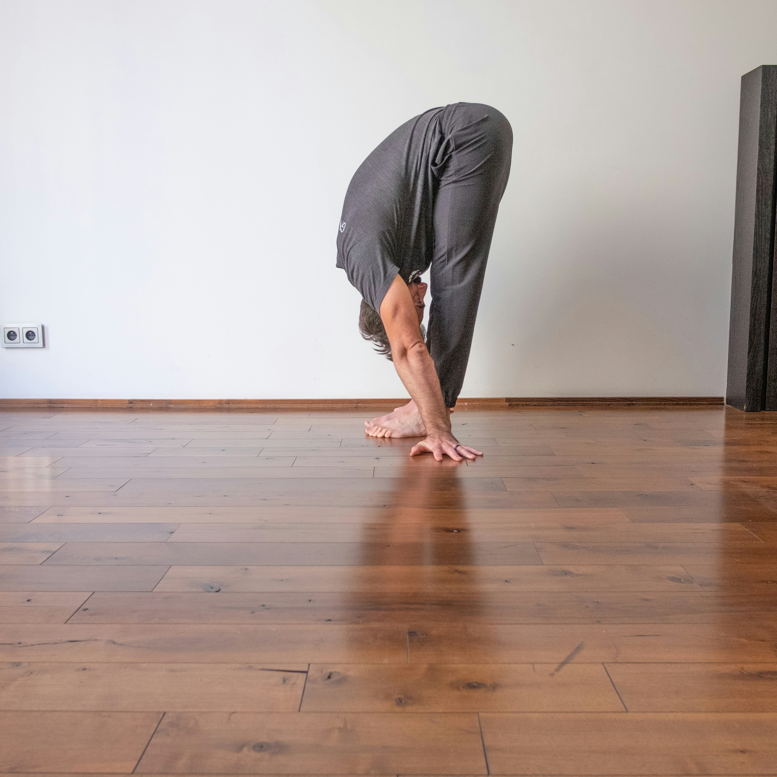 Person stretching in a bright fitness studio